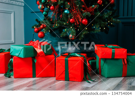 Wrapped Christmas gifts surround the beautifully adorned tree, creating a wonderfully cozy holiday atmosphere thats full of joy and cheer for everyone to enjoy during this special festive season Wrapped Christmas gifts surround the beautifully adorned tree, creating a wonderfully cozy holiday atmosphere thats full of joy and cheer for everyone to enjoy during this special festive season 134754004