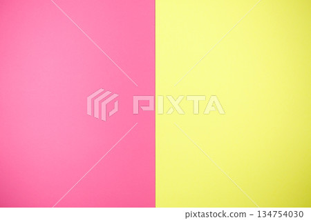 Two pieces of pink and yellow paper are beside each other Two pieces of pink and yellow paper are beside each other 134754030