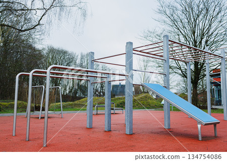 A playground featuring a blue bench prominently located in the middle A playground featuring a blue bench prominently located in the middle 134754086