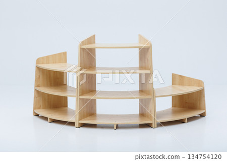 A wooden shelf is currently resting on a clean white surface A wooden shelf is currently resting on a clean white surface 134754120
