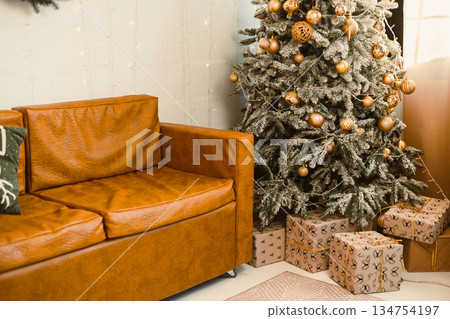 A cozy living room, adorned with a charming Christmas tree and festive decorations, creates a warm atmosphere perfect for the holiday season, embodying joy and comfort for gatherings A cozy living room, adorned with a charming Christmas tree and festive decorations, creates a warm atmosphere perfect for the holiday season, embodying joy and comfort for gatherings 134754197