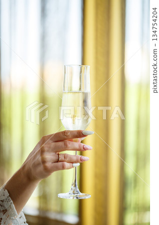 An Elegant Champagne Toast with a Gesture of Celebration to mark a special occasion 134754204