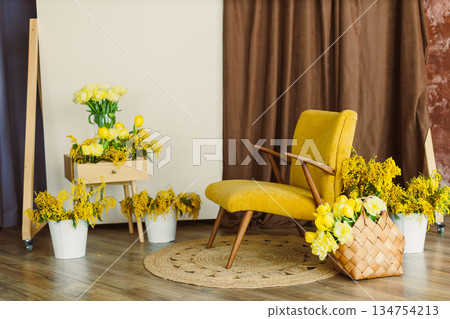 Charming yellow floral decor beautifully arranged with a vintage chair, all set in a bright and inviting studio environment that radiates warmth and style, perfect for any creative space 134754213