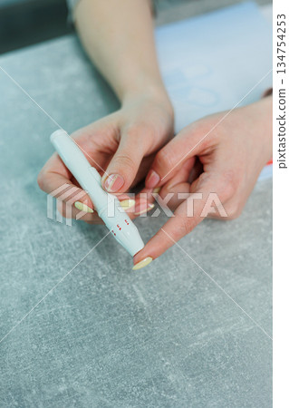 A CloseUp View of Hands Skillfully Using a White Pen for Various Creative Arts and Crafts Projects, Showcasing the Intricate Details and Techniques Involved in Artistic Expression and Design A CloseUp View of Hands Skillfully Using a White Pen for Various Creative Arts and Crafts Projects, Showcasing the Intricate Details and Techniques Involved in Artistic Expression and Design 134754253