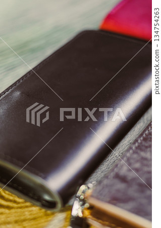 An Elegant Leather Wallet Collection beautifully displayed on a Rustic Wooden Surface This setting is perfect for showcasing Fashion and Accessory Photography, capturing the essence of style An Elegant Leather Wallet Collection beautifully displayed on a Rustic Wooden Surface This setting is perfect for showcasing Fashion and Accessory Photography, capturing the essence of style 134754263