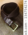 Introducing a Stylish Brown Leather Belt featuring a sturdy Brass Buckle, an ideal accessory that complements any outfit, whether for casual wear or more formal occasions, enhancing your overall look 134754274