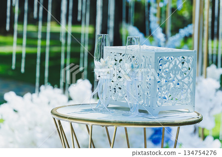 Beautiful and Elegant Wedding Decor Featuring Toasting Glasses and Lovely White Flowers 134754276