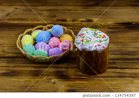 Easter cake and easter eggs on a wooden table Easter cake and easter eggs on a wooden table 134754397