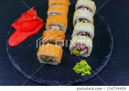 Set of sushi rolls on a black stone slate 134754409