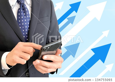 Businessman, smartphone and rising arrow Businessman, smartphone and rising arrow 134755093