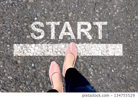 The feet of a woman standing at the starting line 134755529