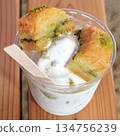 A sweet treat of soft serve ice cream served with pistachios and baklava, a Middle Eastern specialty. 134756239