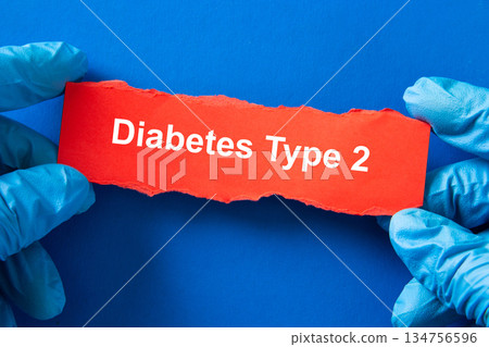 Hands in medical gloves holding paper with diabetes type 2 text 134756596