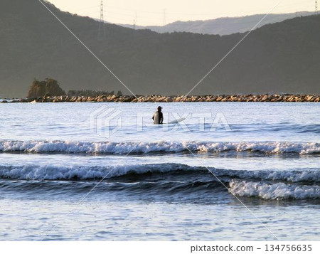 Crashing waves and surfer silhouette 134756635