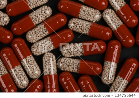 Red and Clear Pharmaceutical Capsules with Medicine Granules Red and Clear Pharmaceutical Capsules with Medicine Granules 134756644