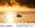 A fishing boat bathed in the morning sun on the Seto Inland Sea shrouded in sea mist 134756717