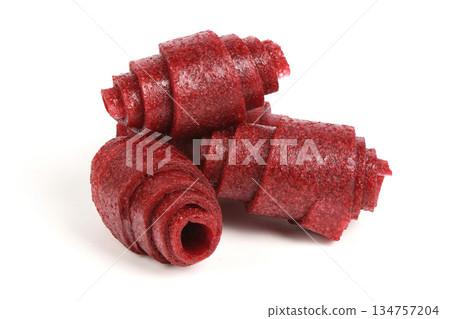 Red Strawberry or Raspberry Fruit Leather Rolls Isolated 134757204
