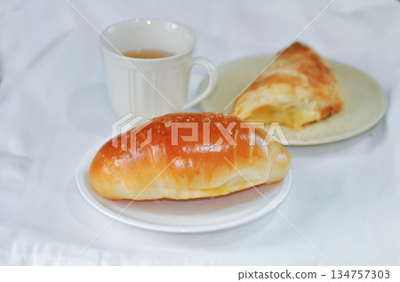 Shio Pan, Salzstangerl bread or Austria bread or Japanese bread with puff and hot tea Shio Pan, Salzstangerl bread or Austria bread or Japanese bread with puff and hot tea 134757303