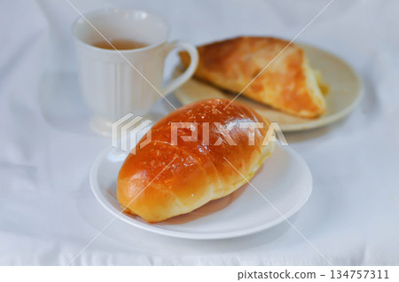 Shio Pan, Salzstangerl bread or Austria bread or Japanese bread with puff and hot tea Shio Pan, Salzstangerl bread or Austria bread or Japanese bread with puff and hot tea 134757311