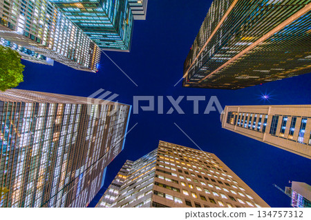 Tokyo Cityscape in Japan: Towards an era of wisdom. The Otemachi office district is shining brightly despite it being the end of the work year. Towards a new era = December 26th 134757312