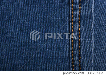 Denim fabric with yellow thread seams, denim jacket, denim pants, for background or fabric sample sale. 134757434