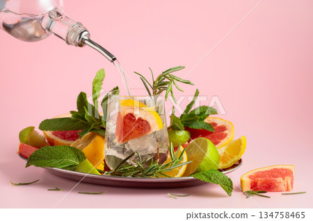 Cocktail with ice, citrus, rosemary and mint. Cocktail with ice, citrus, rosemary and mint. 134758465