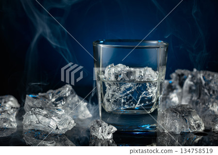 Crystal clear vodka or gin in a glass with ice. Crystal clear vodka or gin in a glass with ice. 134758519