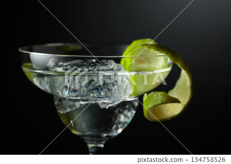 Chilled martini with ice and a twist of lime peel. Chilled martini with ice and a twist of lime peel. 134758526