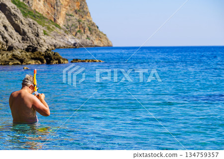 Man with snorkeling tube in sea 134759357
