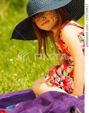 Cute little girl in big hat pretending to be lady Cute little girl in big hat pretending to be lady 134759417