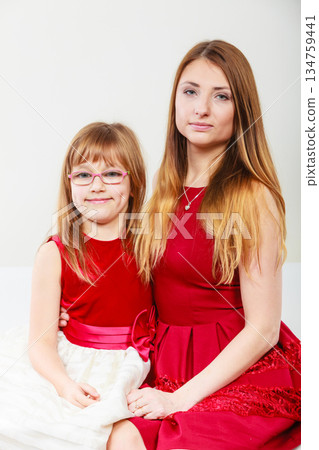 Mother and daughter posing together Mother and daughter posing together 134759441