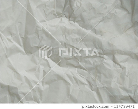 Abstract texture of crumpled paper. The paper exhibits numerous folds, wrinkles, and shadows Abstract texture of crumpled paper. The paper exhibits numerous folds, wrinkles, and shadows 134759471