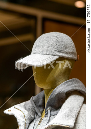Grey Wool Coat and Cap On Mannequin Display In Store Window For Winter Fashion Grey Wool Coat and Cap On Mannequin Display In Store Window For Winter Fashion 134759781
