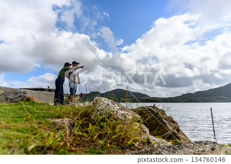 Two people pointing at the view by the water (Photography cooperation: Oki Seaside Resort Miyabi) 134760146