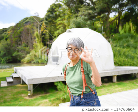 Senior women make peace signs in front of the dome tent. Senior women make peace signs in front of the dome tent. 134760604