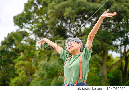 Elderly woman stretching outdoors Elderly woman stretching outdoors 134760611