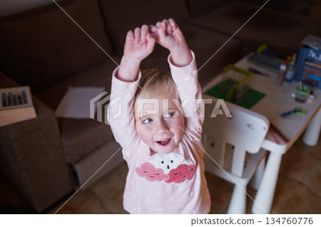 Little Girl Smiling and Seeking Favor from Parents Little Girl Smiling and Seeking Favor from Parents 134760776