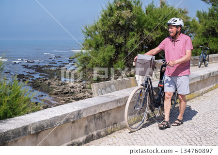 Elderly Man with Mustache and Helmet Riding a Bicycle Elderly Man with Mustache and Helmet Riding a Bicycle 134760897