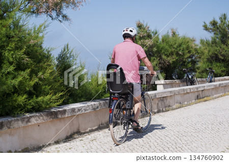 Elderly Man with Mustache and Helmet Riding a Bicycle Elderly Man with Mustache and Helmet Riding a Bicycle 134760902