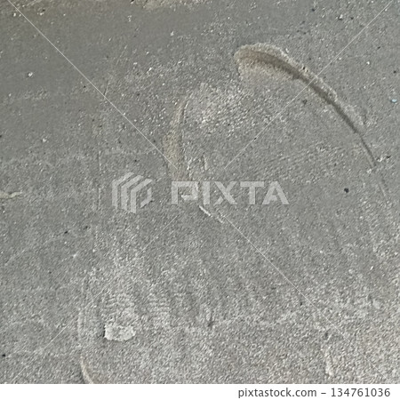 Close-up of subtle footprints in a layer of dust. This image provides a textured background, perfect for adding depth to designs, overlays, or creative projects. Evokes mystery and storytelling. Close-up of subtle footprints in a layer of dust. This image provides a textured background, perfect for adding depth to designs, overlays, or creative projects. Evokes mystery and storytelling. 134761036