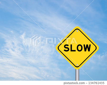 Yellow transportation sign with word slow on blue color sky background 134761435