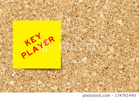 Yellow note paper with word key player on cork board background with copy space Yellow note paper with word key player on cork board background with copy space 134761440