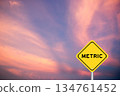 Yellow transportation sign with word metric on violet color sky background 134761452