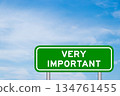 Green color transportation sign with word very important on blue sky with white cloud background 134761455