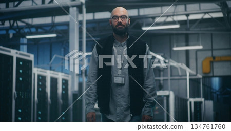 Internal Audit Specialist Inspecting Equipment in Industrial Server Space 134761760