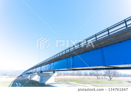 Blue bridge and snowy mountains Blue bridge and snowy mountains 134761847