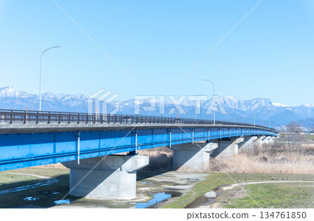 Blue bridge and snowy mountains Blue bridge and snowy mountains 134761850