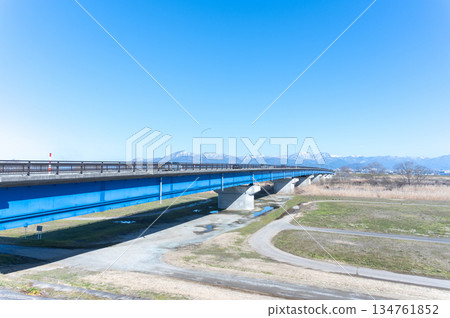 Blue bridge and snowy mountains Blue bridge and snowy mountains 134761852