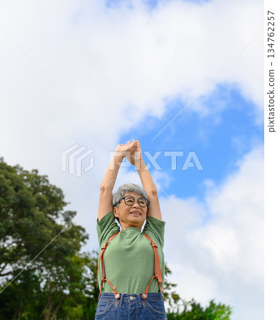 Elderly woman stretching outdoors Elderly woman stretching outdoors 134762257