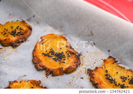 Oven baked sweet potato chips 134762421
